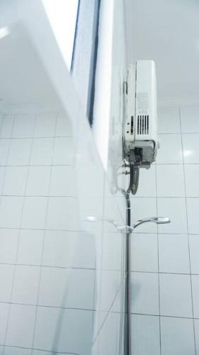 una cámara de seguridad en el lateral de un edificio en Cozy Haven with Jacuzzi, Rooftop, en Bandung