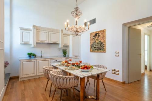 a kitchen with a table with a bowl of fruit on it at Maison Mirò with private parking in Lucca