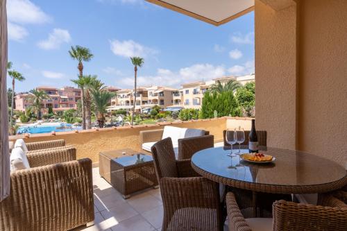 a patio with a table and chairs with a view of the beach at Tropical Paradise in Harbour Paphos, Central & Close to Beach in Paphos