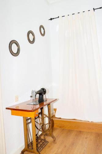 a table with a sewing machine on it next to a window at El Patio de los Naranjos in Guadalupe