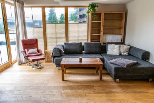 a living room with a couch and a coffee table at Weinzeit Chalet in Königsleiten