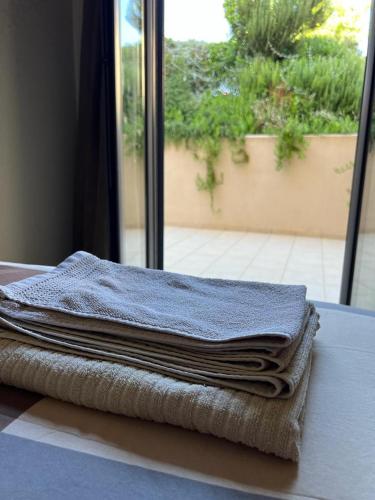 a pile of folded towels sitting on a table at Pool apartment 5 minutes walk from beach in Porto Rafti