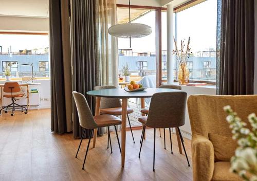 a dining room with a table and chairs in a room at Charlottehaven in Copenhagen