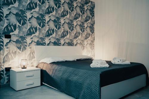 a bedroom with a bed with a green and white wallpaper at Design & Giardino con Sauna & Hammam - Free WiFi in Margarita