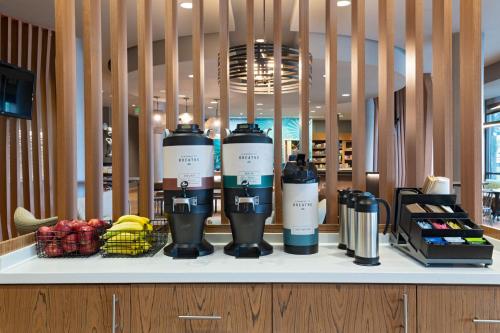 a shelf with three bottles on it with fruit at Springhill Suites by Marriott Anaheim Maingate in Anaheim