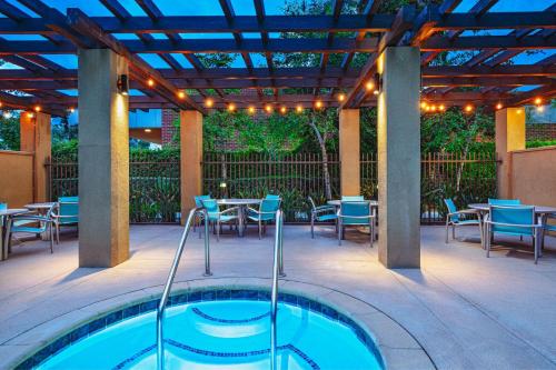 a patio with a hot tub and tables and chairs at Springhill Suites by Marriott Anaheim Maingate in Anaheim