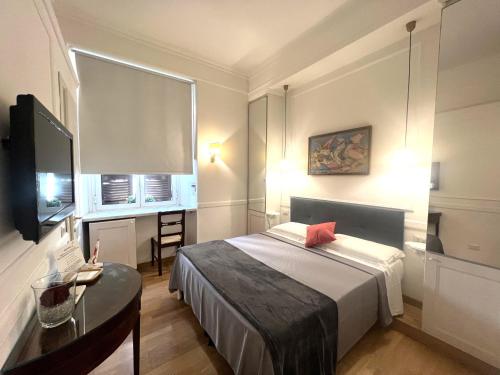 a bedroom with a bed and a table and a television at INTERNO ROMA in Rome