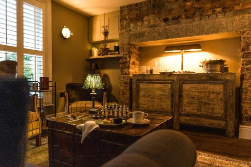 un soggiorno con tavolo in una stanza con parete in pietra di Regency House a Belfast
