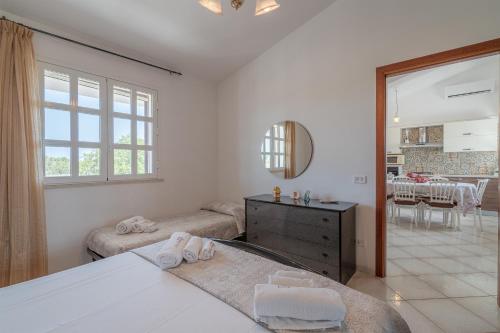 a bedroom with a bed and a dining room at Appartamento con vista su Noto in Noto