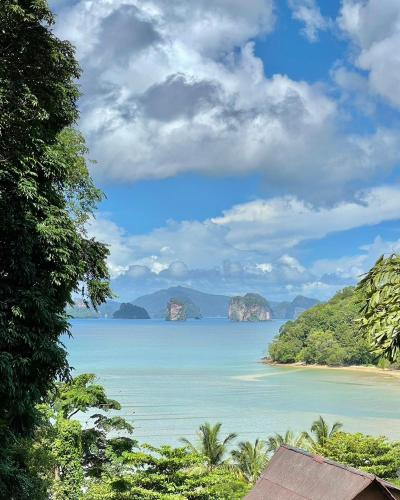 a view of a beach with islands in the water at Hillhouse - Koh Yao Noi in Ko Yao Noi