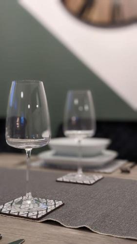 two wine glasses sitting on top of a table at 2 Bedroom apartment in Brean in Brean