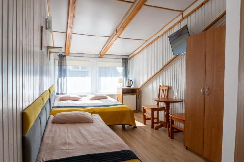 a bedroom with two beds and a window at Piast in Karwia