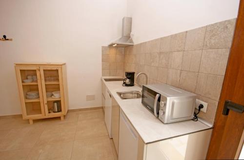 a small kitchen with a microwave on a counter at Agroturisme Rafal Nou in Manacor