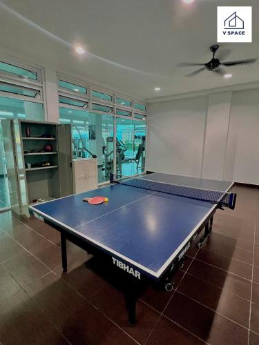 a ping pong table in the middle of a room at Ipoh D Festivo Suites 6-10pax 10mins to Sunway Tambun by IWH in Ipoh
