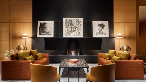 a living room with two couches and a table at Bulgari Hotel Tokyo in Tokyo