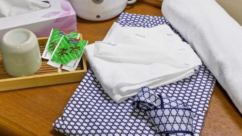 a table topped with blue and white ties on a table at Business Inn Fukuyama in Fukuyama