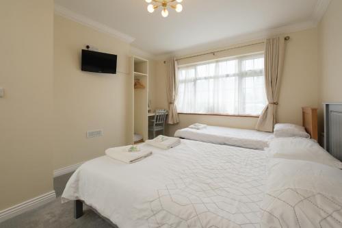a bedroom with two beds and a window at Four Seasons B&B in Galway