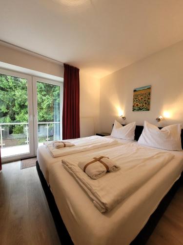 a large bed in a room with a large window at Winterberg Appartement 21085 in Winterberg