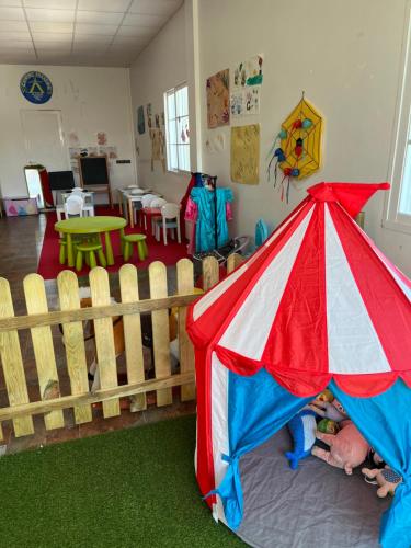 a room with a play area with a tent at Camping Paxariñas in Portonovo