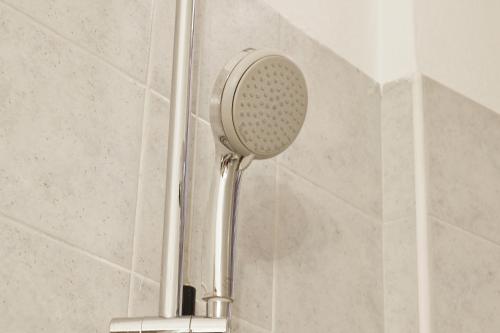 a shower with a shower head in a bathroom at Casina modesta in Somma Lombardo