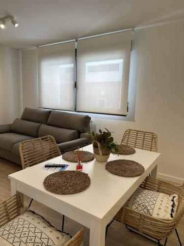 a living room with a white table and chairs at Apartamentos Encanto Mudéjar in Teruel