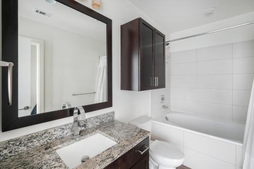 a bathroom with a sink and a toilet and a mirror at Downtown 1br w gym pool deck nr capitol ATX-192 in Austin