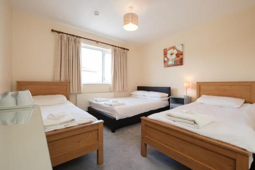 a bedroom with two beds and a window at Four Seasons B&B in Galway