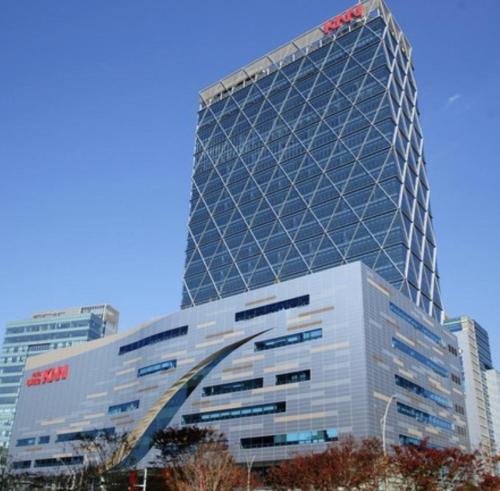 a building with a samsung sign on top of it at Hero Guest Room in Busan