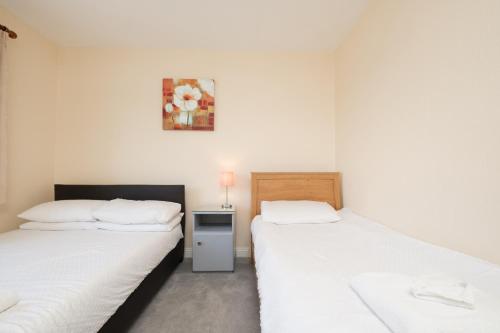 two beds sitting next to each other in a room at Four Seasons B&B in Galway