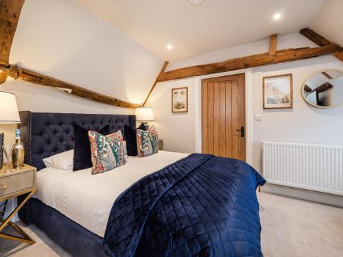 a bedroom with a king sized bed and a wooden door at The Stag, Oak Room in Salhouse