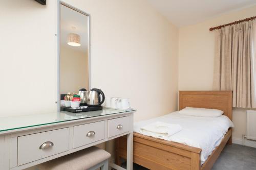 a bedroom with a bed and a mirror at Four Seasons B&B in Galway