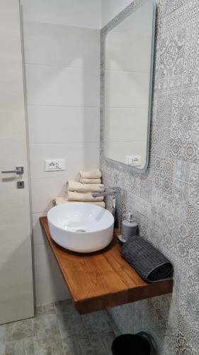 a bathroom with a white sink and a mirror at Luciae Domus in Roccascalegna