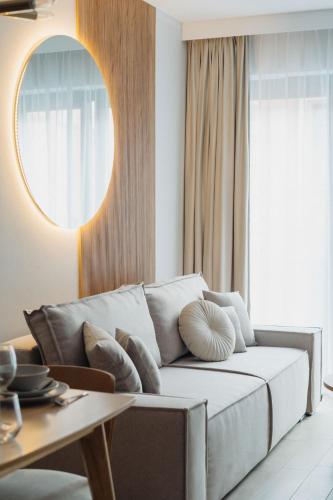 a living room with a couch and a table at Muse - LoftAffair Spa Collection in Kraków