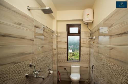 a bathroom with a toilet and a window at Divine's The Elite Zong in Lachung