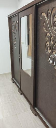 a wooden door with a mirror in a room at One bedroom apartment with sea view in Sousse