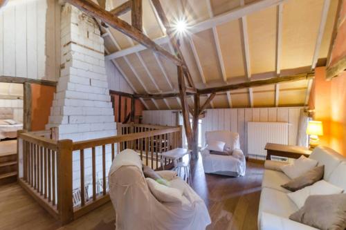 a living room with two couches in a room at La ferme d'octave in Dosches