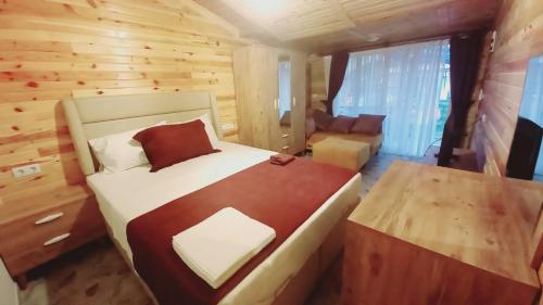 a bedroom with a large bed in a log cabin at ZEYOS LODGE HOTEL&RESTAURANT in Kumluca