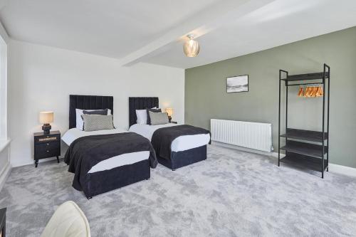 a bedroom with two beds and two tables at Stay House - Rural Retreat in Kepwick
