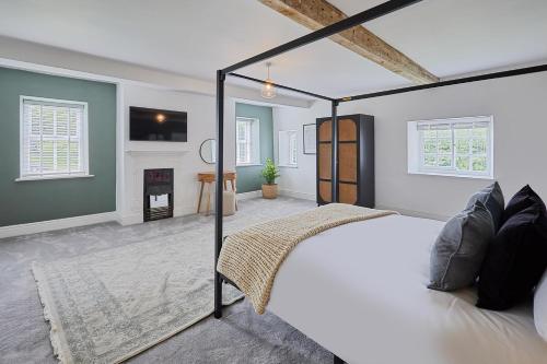 a bedroom with a bed and a fireplace at Stay House - Rural Retreat in Kepwick