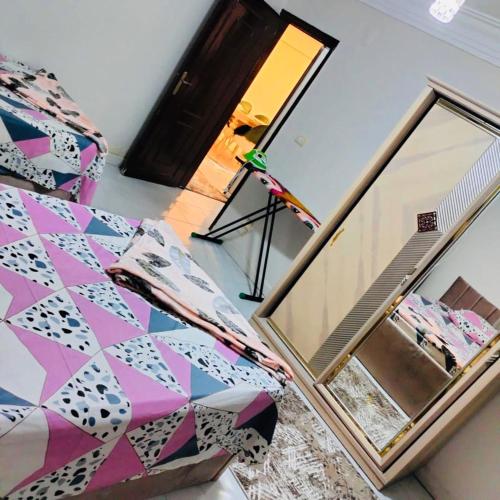 a view of a room with a mirror and a bed at شقه فندقيه مدينه نصر in Alexandria