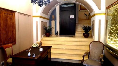 a office with a desk and a chair and a door at Palazzo Zimatore Residenza D'Epoca in Pizzo