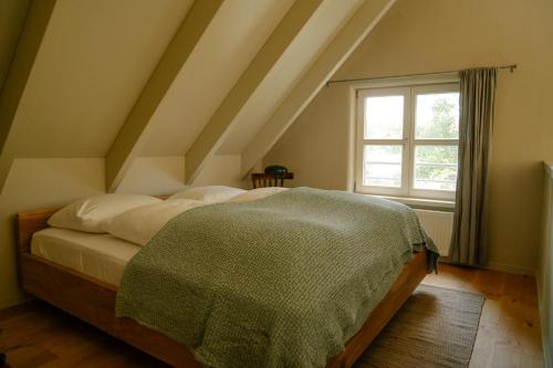 a bedroom with a bed and a window at Michelberger Farm in Vetschau