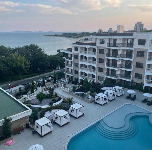 a view of a hotel with a pool and tables at VALENCIA GARDENS ROYAL in Nesebar