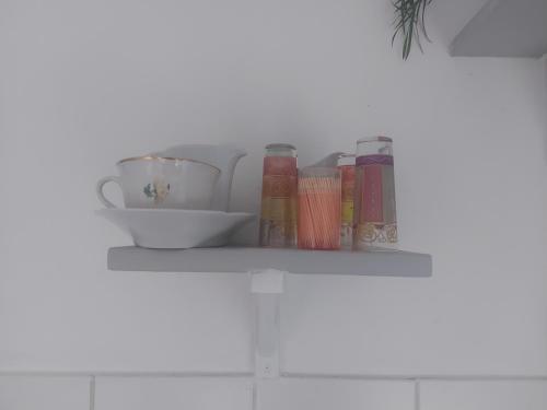 a shelf with books and cups on it at Chez Mambo in Bordeaux