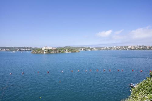a large lake with red buoys in the water at Seth Agamenon in Es Castell