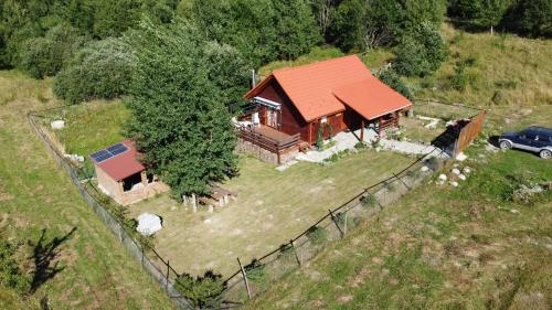 an aerial view of a house with a fence at Cabana Nyiko cu ciubăr in Lupeni