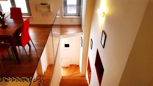 a view of a stairway in a room with a dining table and a room at Palazzo Zimatore Residenza D'Epoca in Pizzo