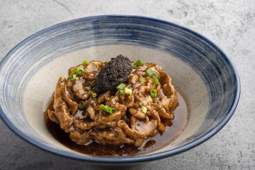 a blue bowl of food with peanuts and green onions at CHAO Sanlitun Beijing in Beijing