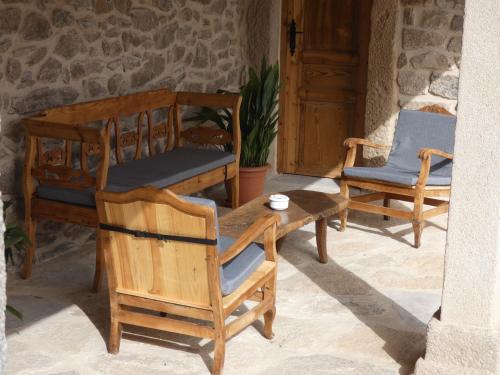 a patio with two chairs and a wooden table and chairs at LA ALCOBA DE SAYAGO in Bermillo de Sayago