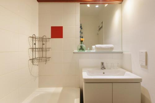 a white bathroom with a sink and a bath tub at Chamonix Sud - Balme 302 - Happy Rentals in Chamonix-Mont-Blanc